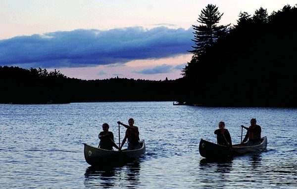 summer camp girls and a canoe at Northway Camp